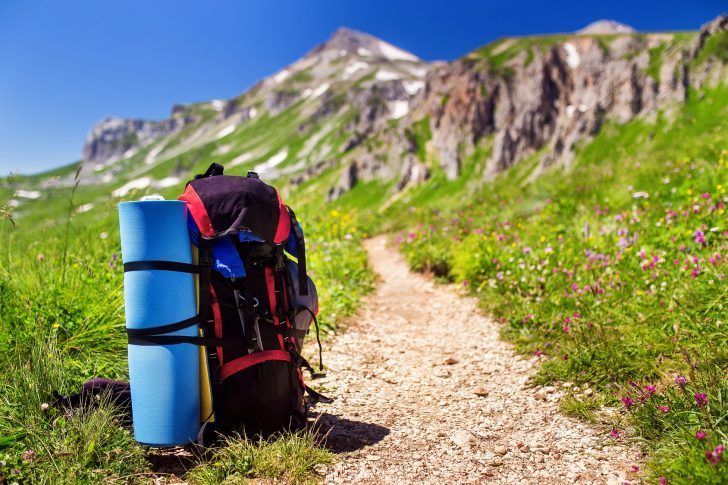 Tourist backpack with a rug near hiking trail in the mountains of the Caucasus, Adygea